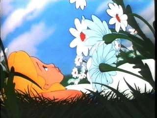 alice in wonderland laying in between the daisies